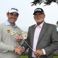 John Solheim presents Louis Oosthuizen with a gold-plated Ping four iron following his Albatross at the Masters